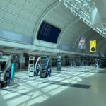 Creative design interior of contemporary airport with corridor under information board and signboards